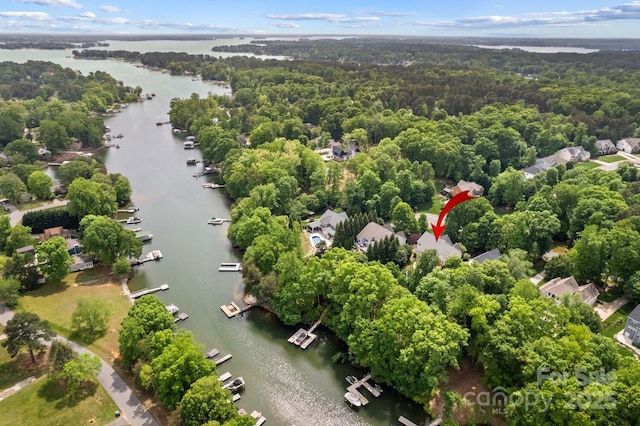 drone / aerial view featuring a water view and a forest view