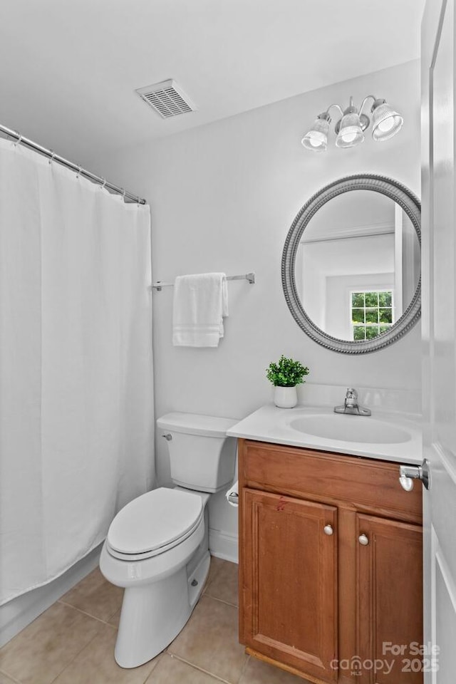 bathroom with toilet, visible vents, tile patterned flooring, and vanity