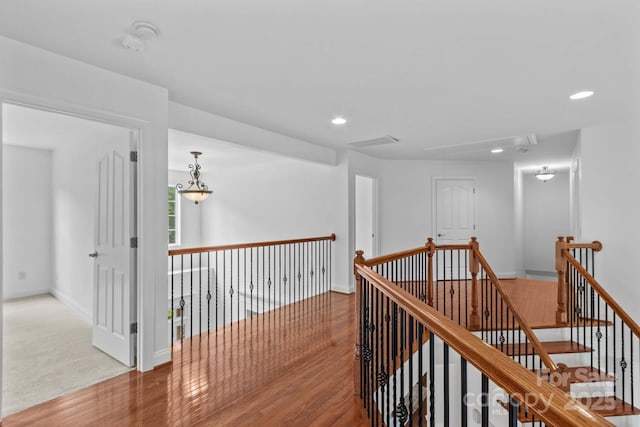 corridor featuring attic access, recessed lighting, baseboards, an upstairs landing, and wood finished floors