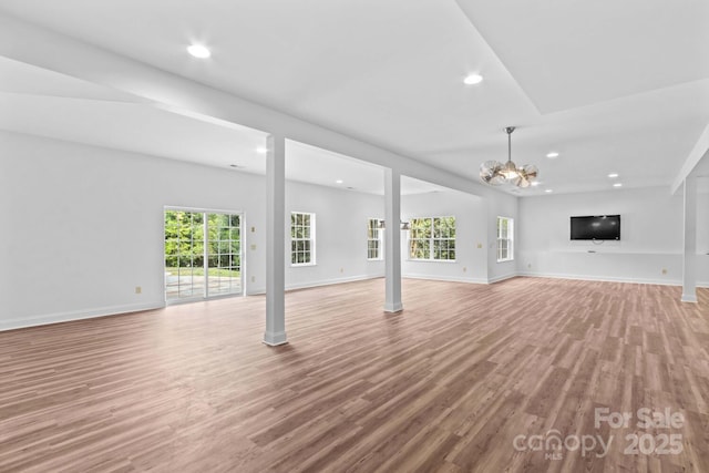 unfurnished living room featuring recessed lighting, baseboards, and light wood-style flooring