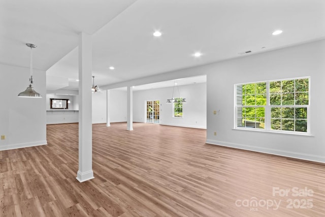 unfurnished living room with recessed lighting, baseboards, visible vents, and light wood-style floors