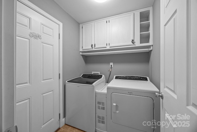 250 Log Barn Rd, Salisbury, NC 28146 - washroom with separate washer and dryer, cabinet space, and light tile patterned floors