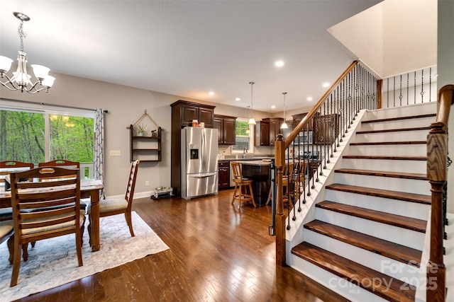 dining area with dark wood-style flooring, stairway, baseboards, a notable chandelier, and recessed lighting