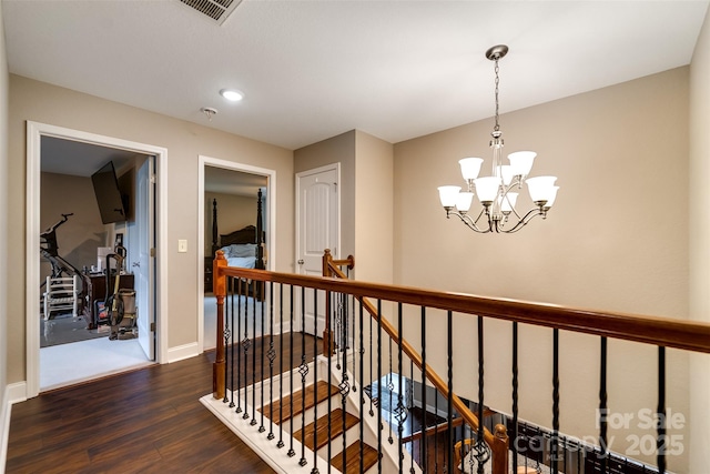 hall featuring an inviting chandelier, recessed lighting, baseboards, an upstairs landing, and dark wood-style floors