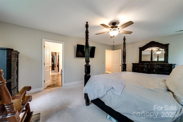 bedroom with visible vents, baseboards, light colored carpet, connected bathroom, and a ceiling fan