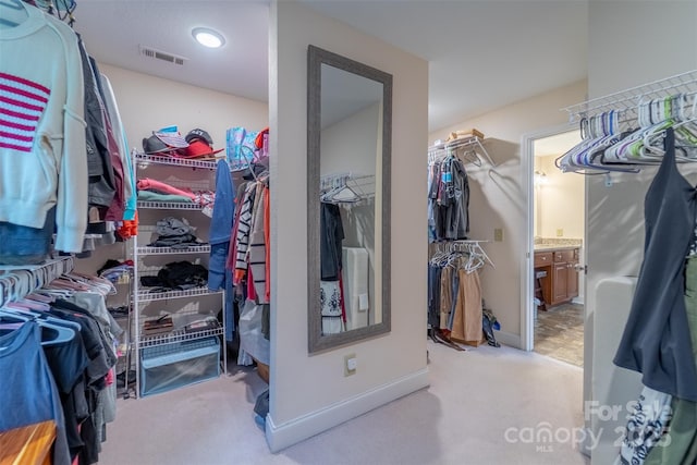 walk in closet featuring carpet and visible vents