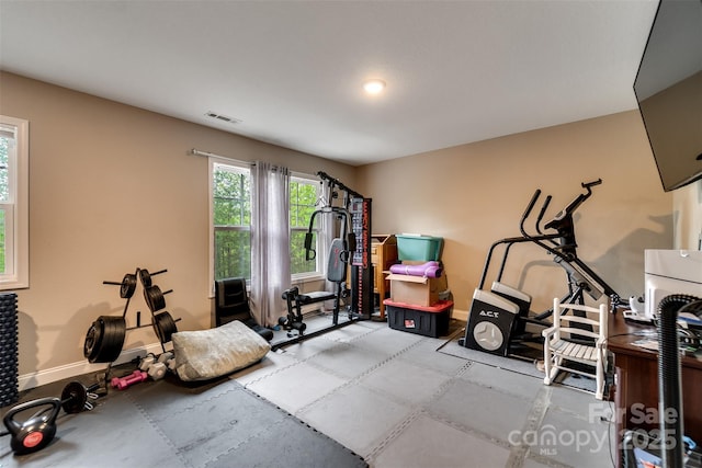 exercise room featuring visible vents and baseboards