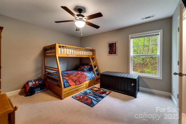 carpeted bedroom with baseboards, visible vents, and ceiling fan