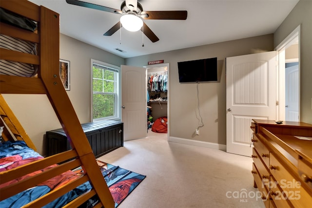 bedroom with light colored carpet, baseboards, a spacious closet, visible vents, and a closet
