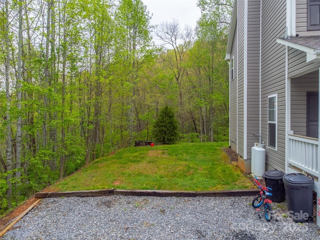 view of yard featuring a forest view