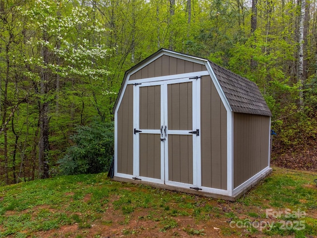 view of shed featuring a wooded view