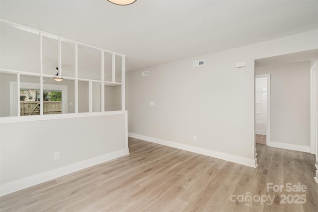 empty room featuring baseboards and wood finished floors