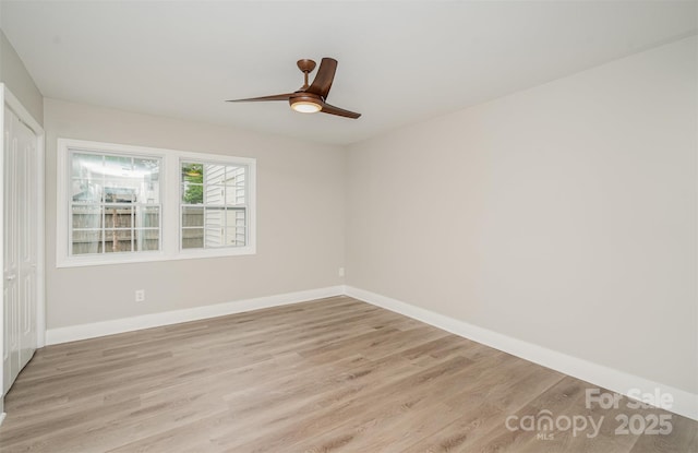 unfurnished room featuring light wood finished floors, a ceiling fan, and baseboards