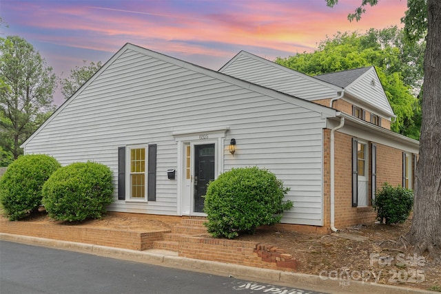 view of front of home featuring brick siding
