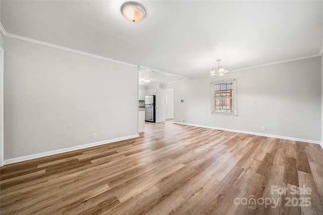 115 K M Murphy Rd, Gastonia, NC 28056 - unfurnished living room featuring light wood finished floors, a notable chandelier, and baseboards