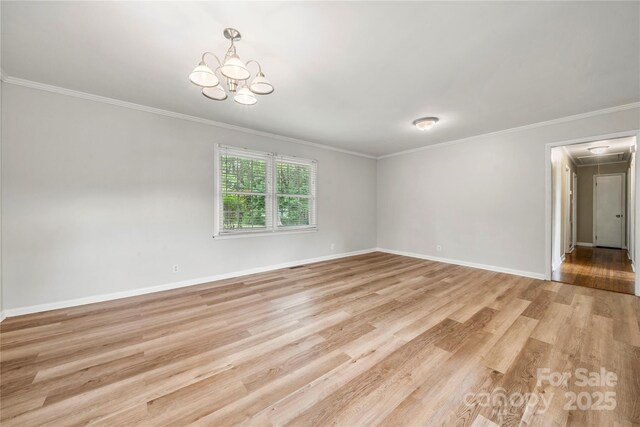 115 K M Murphy Rd, Gastonia, NC 28056 - empty room featuring light wood-style flooring, a chandelier, attic access, ornamental molding, and baseboards