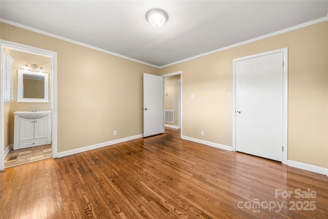 115 K M Murphy Rd, Gastonia, NC 28056 - unfurnished bedroom with wood finished floors, visible vents, crown molding, and baseboards