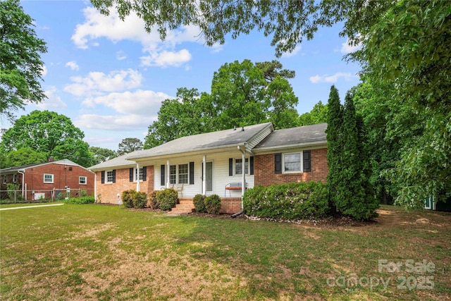 115 K M Murphy Rd, Gastonia, NC 28056 - ranch-style house featuring fence, a front lawn, a porch, and brick siding