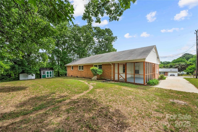 115 K M Murphy Rd, Gastonia, NC 28056 - single story home with brick siding, an outbuilding, a shed, a sunroom, and a front lawn