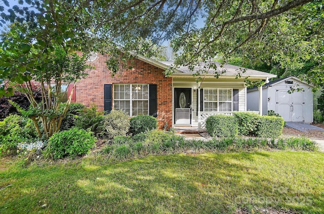 519 Jacobs Rdg, Fort Mill, SC 29715 - view of front facade with a storage unit, a front yard, an outbuilding, and brick siding