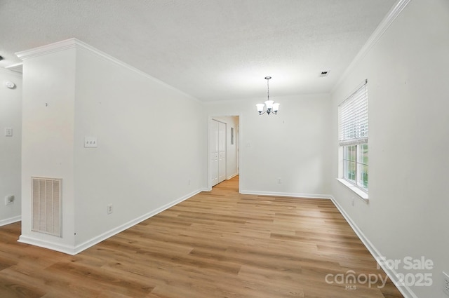 519 Jacobs Rdg, Fort Mill, SC 29715 - unfurnished dining area featuring crown molding, a chandelier, light wood-style flooring, baseboards, and a textured ceiling
