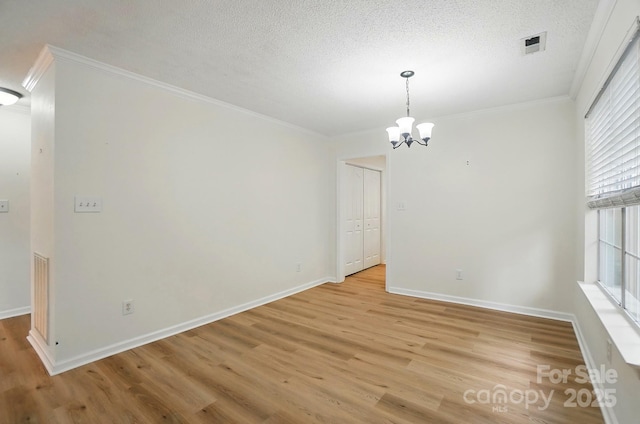 519 Jacobs Rdg, Fort Mill, SC 29715 - unfurnished dining area with light wood-style flooring, crown molding, a chandelier, baseboards, and a textured ceiling