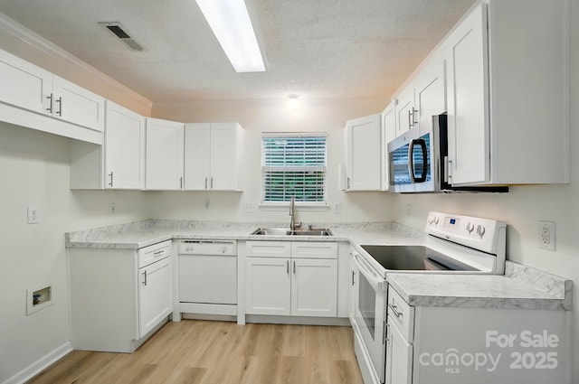 519 Jacobs Rdg, Fort Mill, SC 29715 - kitchen featuring white appliances, a sink, light wood-type flooring, white cabinets, and light countertops