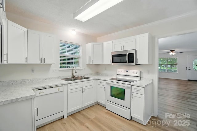 519 Jacobs Rdg, Fort Mill, SC 29715 - kitchen featuring white appliances, a sink, light wood-style floors, white cabinetry, and ornamental molding