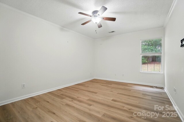 519 Jacobs Rdg, Fort Mill, SC 29715 - spare room featuring crown molding, ceiling fan, a textured ceiling, baseboards, and light wood finished floors