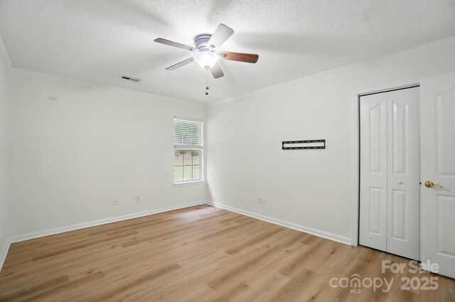 519 Jacobs Rdg, Fort Mill, SC 29715 - spare room featuring a textured ceiling, light wood-style floors, crown molding, a ceiling fan, and baseboards