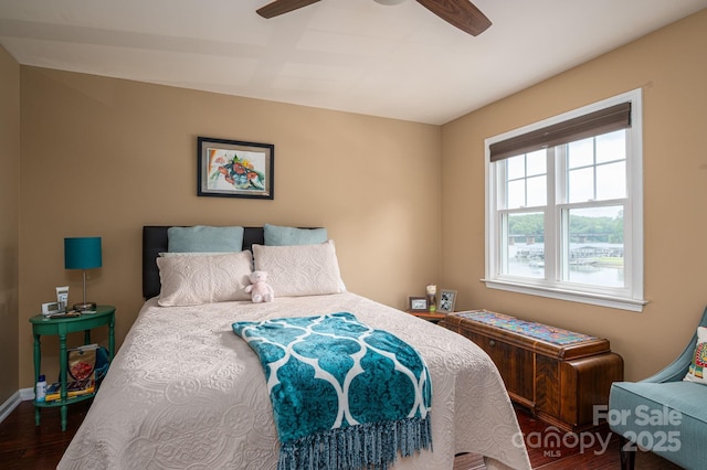 bedroom with baseboards, ceiling fan, and wood finished floors