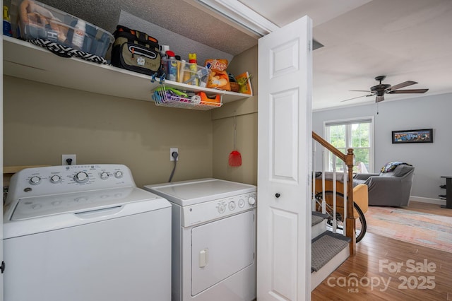 laundry room with washing machine and clothes dryer, a ceiling fan, laundry area, and light wood-style floors