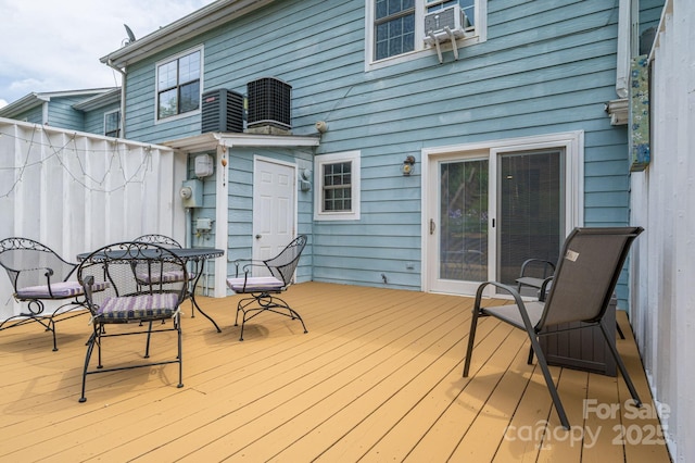 deck featuring central air condition unit, cooling unit, and outdoor dining space