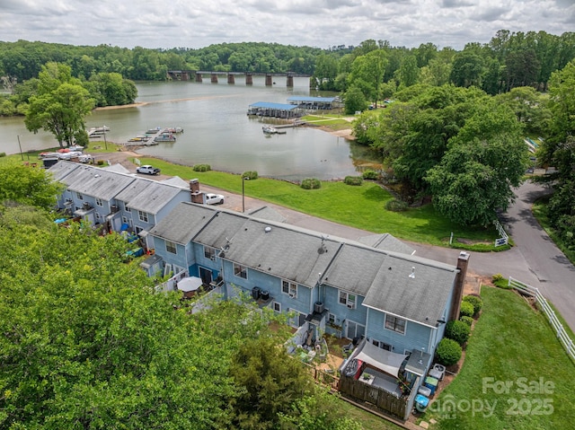 aerial view with a water view and a wooded view
