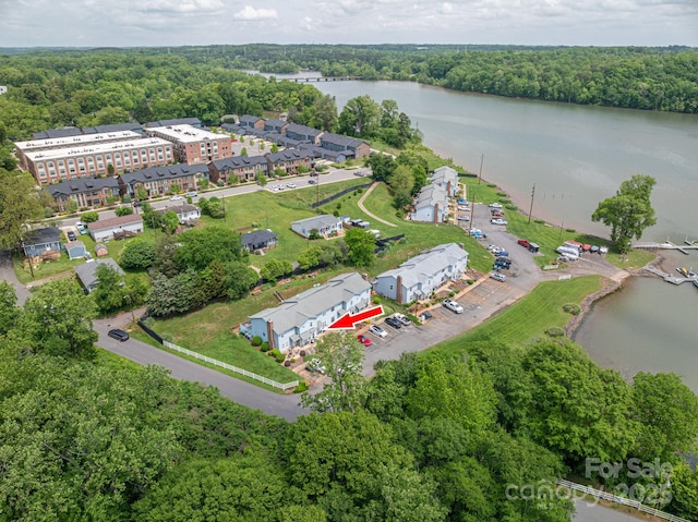 bird's eye view with a water view and a view of trees