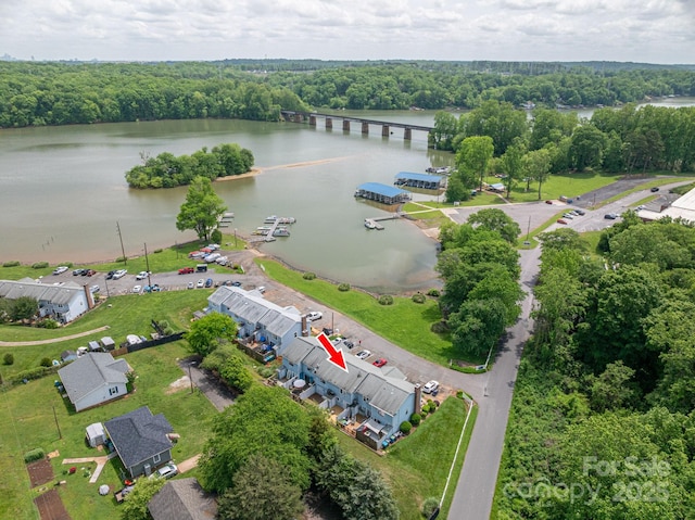birds eye view of property featuring a water view and a forest view