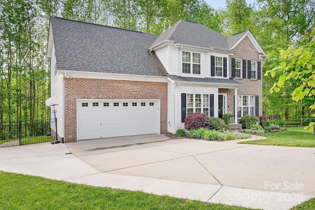 view of front of home with fence, an attached garage, roof with shingles, and concrete driveway