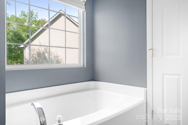 bathroom with a garden tub