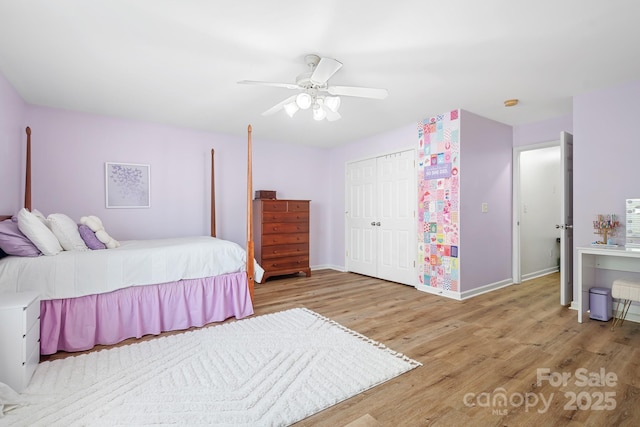 bedroom with baseboards, wood finished floors, a closet, and ceiling fan