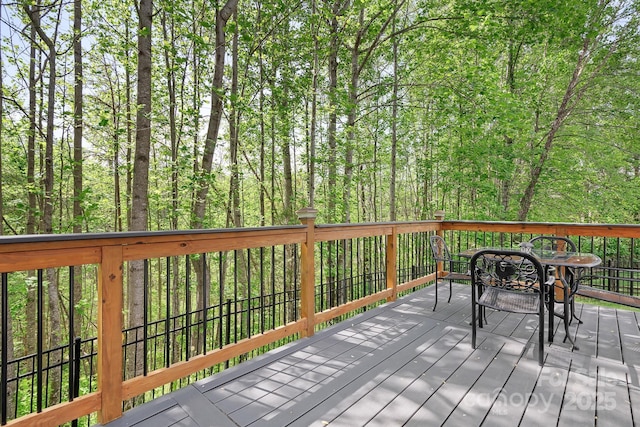 wooden terrace with a view of trees