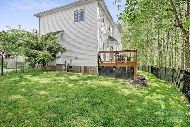 rear view of property with a lawn, a fenced backyard, and a deck