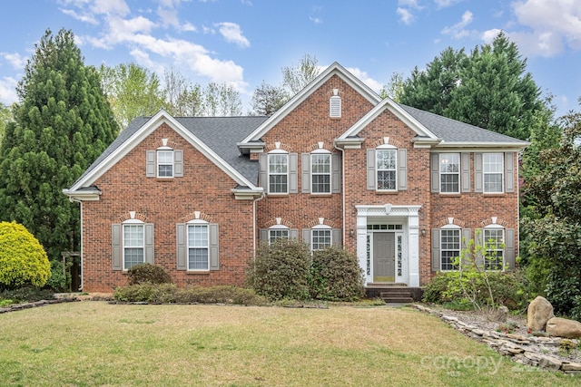 2620 Shady Reach Ln, Charlotte, NC 28214 - colonial inspired home featuring a shingled roof, brick siding, and a front yard