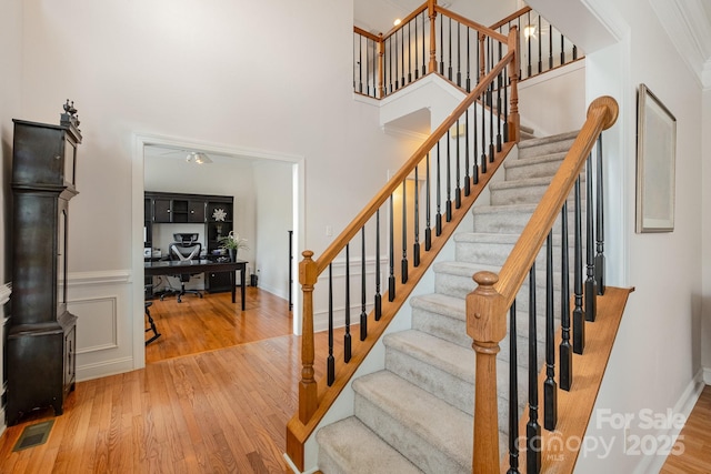 2620 Shady Reach Ln, Charlotte, NC 28214 - stairway with baseboards, a high ceiling, wood finished floors, and visible vents