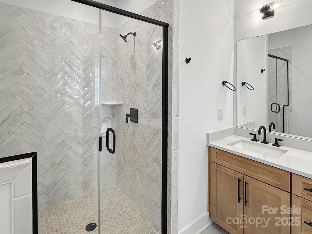 bathroom with a stall shower and vanity