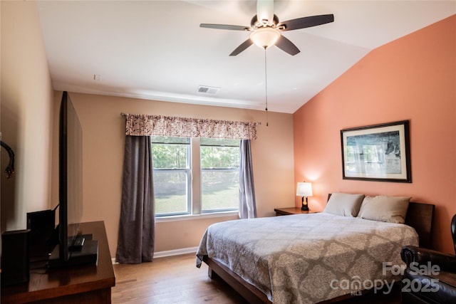 bedroom featuring light wood-style flooring, vaulted ceiling, ceiling fan, baseboards, and visible vents