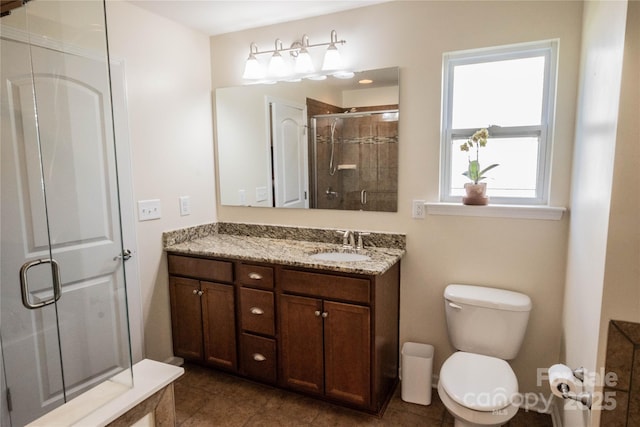bathroom with tile patterned floors, a shower stall, toilet, and vanity