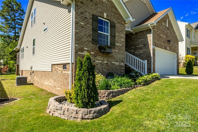 view of side of property featuring a lawn, concrete driveway, and brick siding