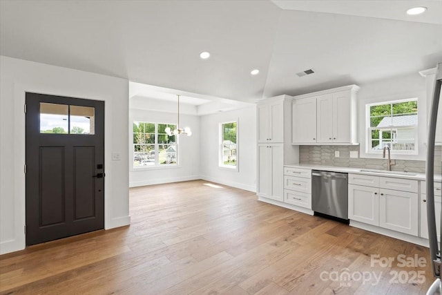 2429/2425 Ellen Ave, Charlotte, NC 28208 - kitchen featuring light countertops, dishwasher, visible vents, a sink, and a notable chandelier
