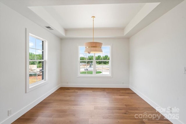 2429/2425 Ellen Ave, Charlotte, NC 28208 - unfurnished room featuring visible vents, baseboards, wood finished floors, and a raised ceiling