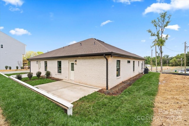 2429/2425 Ellen Ave, Charlotte, NC 28208 - back of property with central AC unit, brick siding, a patio area, a shingled roof, and a yard